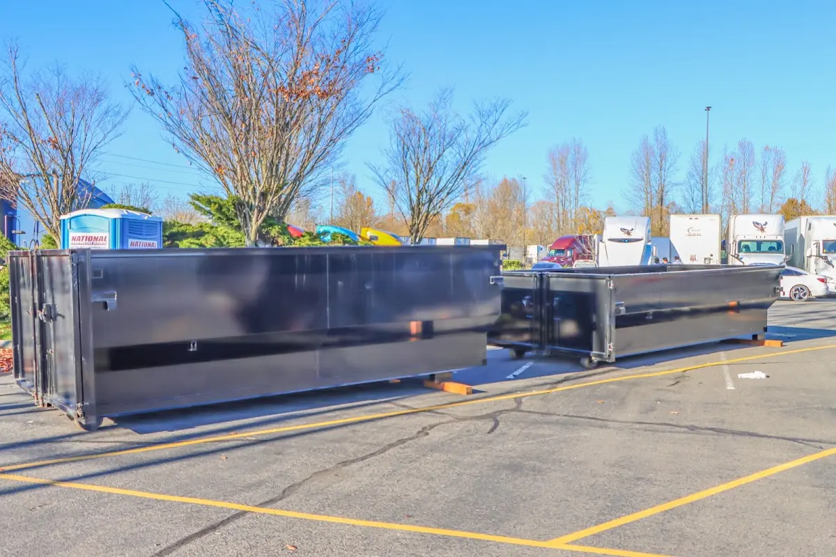 Professional dumpster rental service with roll-off container on residential driveway in Shelley